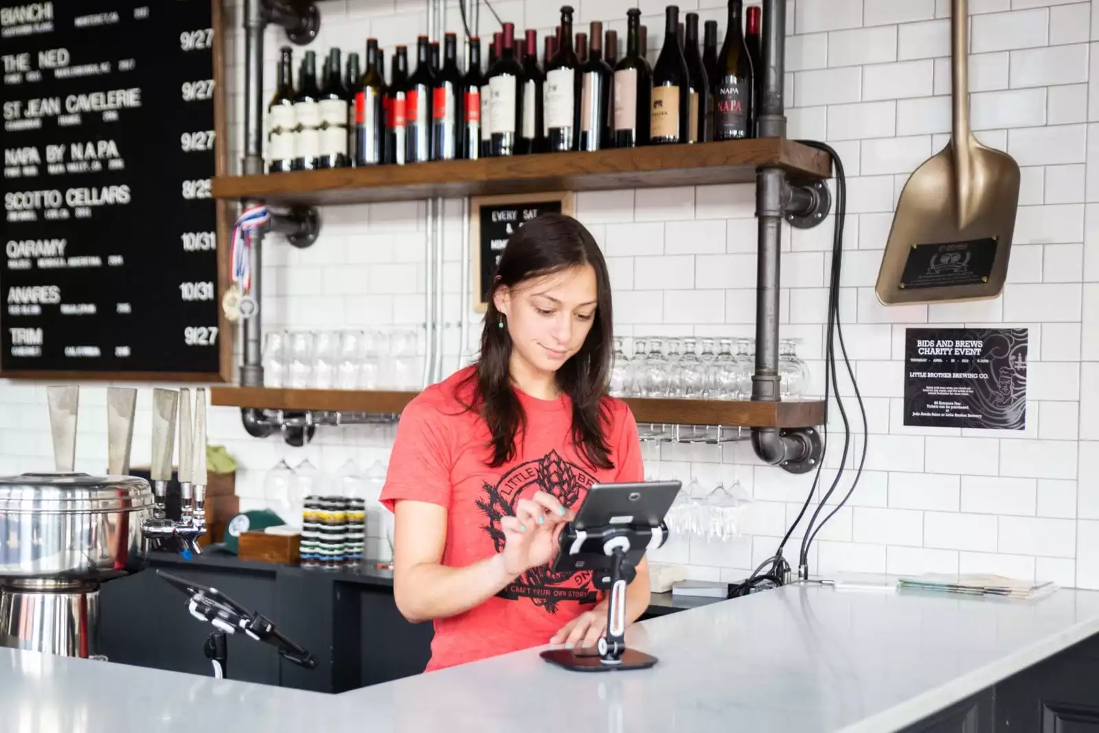 winery employee using POS DTC software in the tasting room