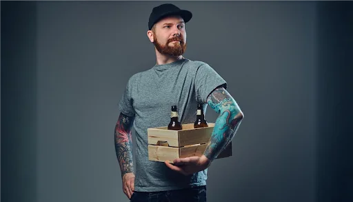 man holding beers in crate